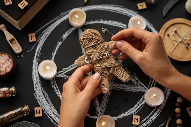 Free Photo top view hands holding voodoo doll