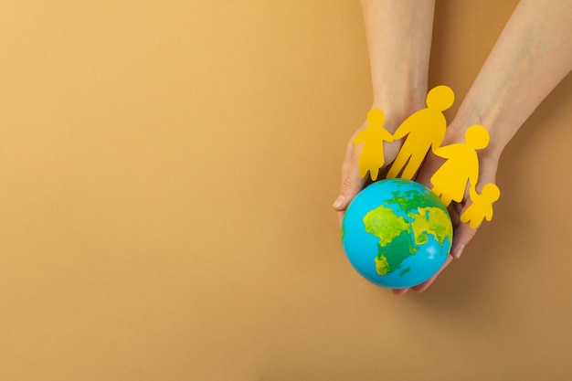 Free photo top view hands holding world globe