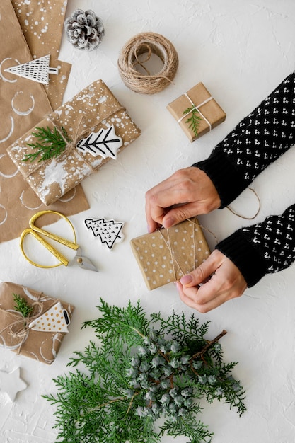 Free photo top view of hands preparing christmas gifts