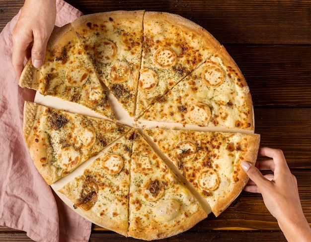 Free photo top view hands taking slices of pizza with cheese