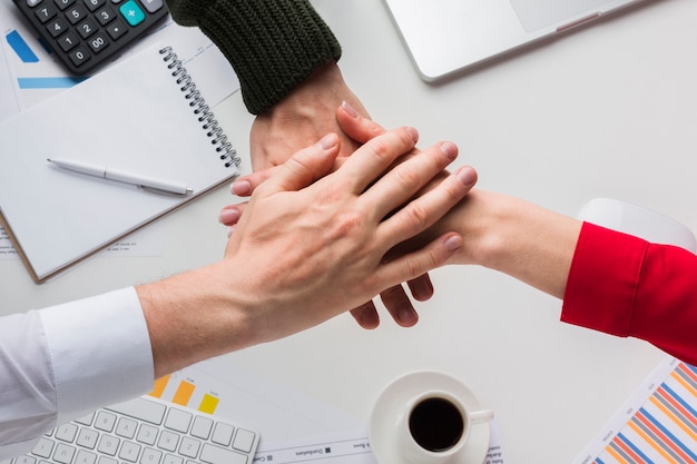 Free Photo top view of hands together over desk