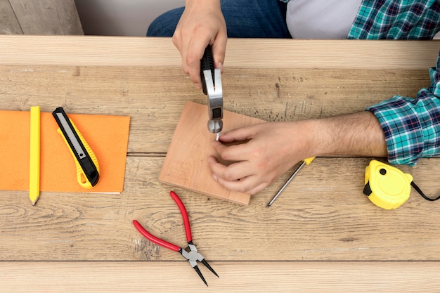 Free Photo top view hands using hammer and nails