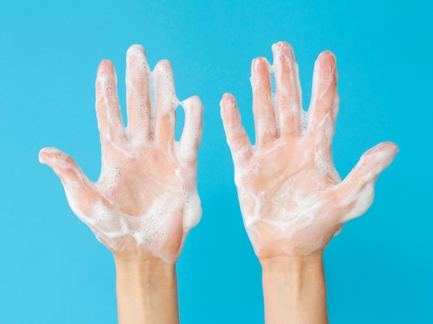 Free photo top view of hands with foam from soap