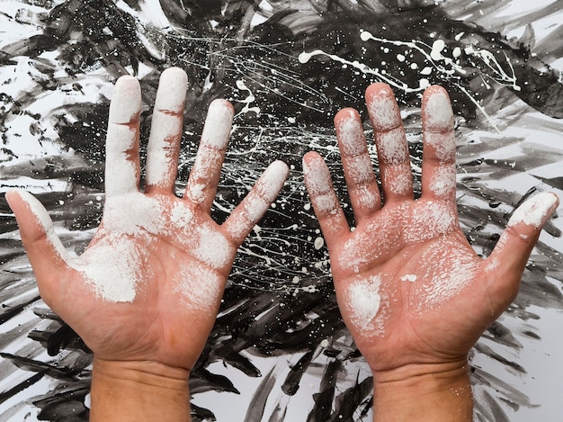 Top view of hands with palms covered in paint