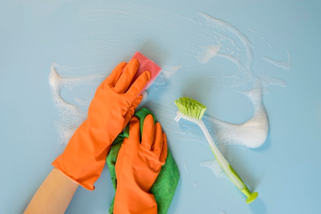 Free Photo top view hands with rubber gloves cleaning