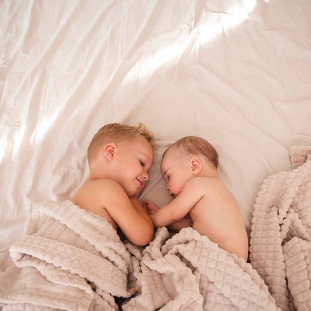 Top view of happy siblings indoors