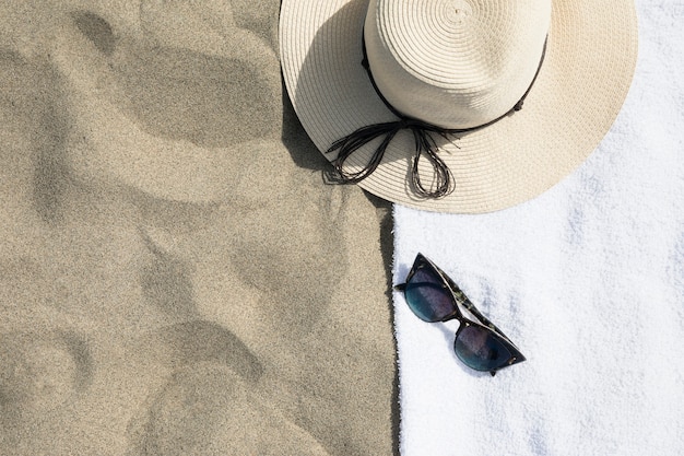 Top view of hat on beach towel