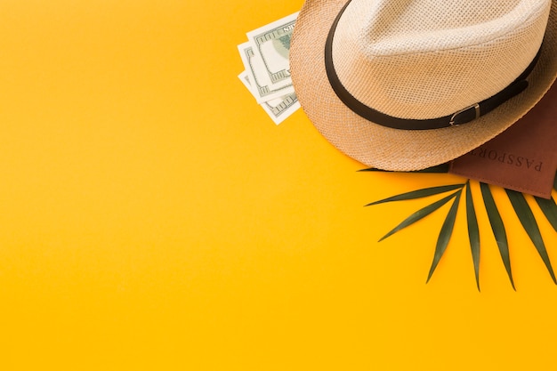 Top view of hat and passport with money and copy space