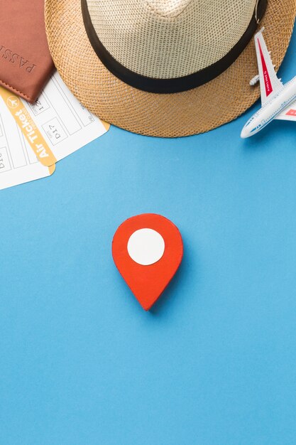 Top view of hat and travel essentials with pinpoint