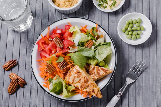 Top view of healthy dish with wooden background