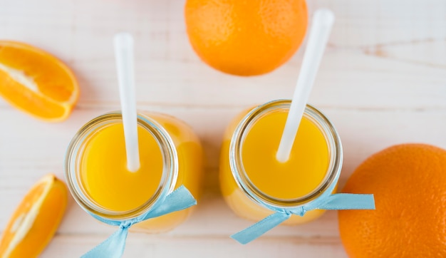 Free photo top view healthy orange juice on the table