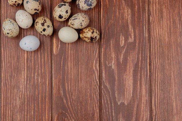 Top view of healthy quail eggs on a wooden background with copy space