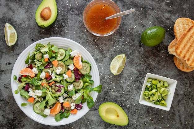 Free photo top view healthy salad with avocado and toast