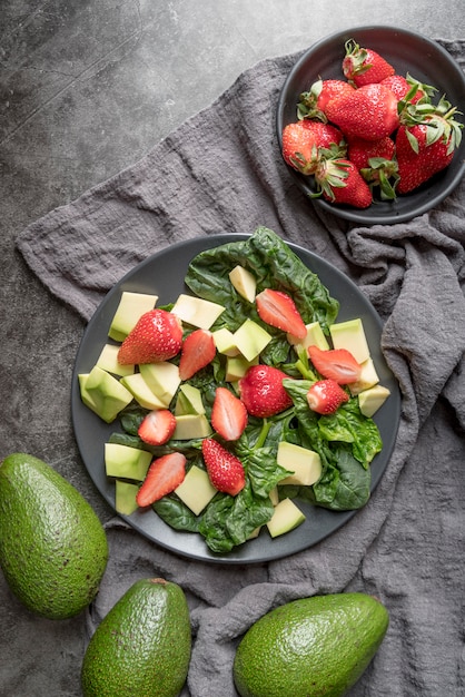 Free photo top view healthy salad with strawberries and avocado