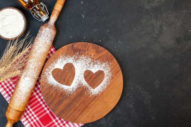 Top view heart shaped flour with oil and white flour on a dark background sugar color cake white tea cookie salad food biscuit