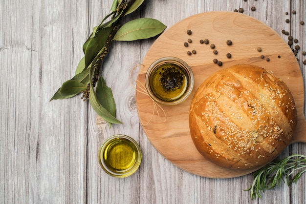 Free photo top view homemade bread and olive oil