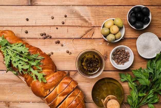 Free Photo top view homemade bread and olives on the table