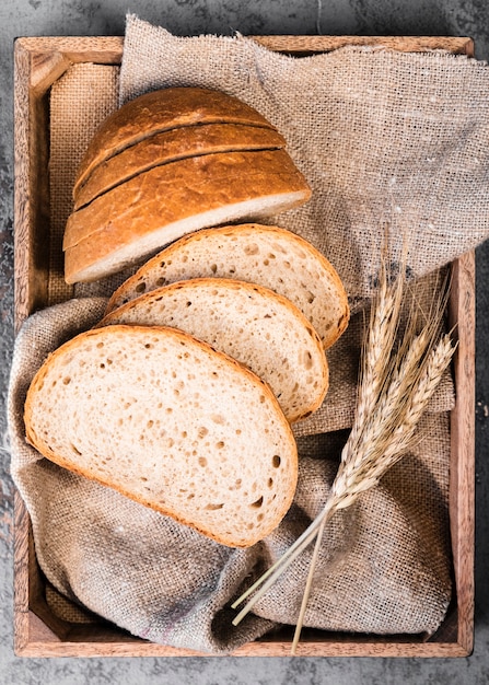 Free Photo top view homemade slices of bread and wheat