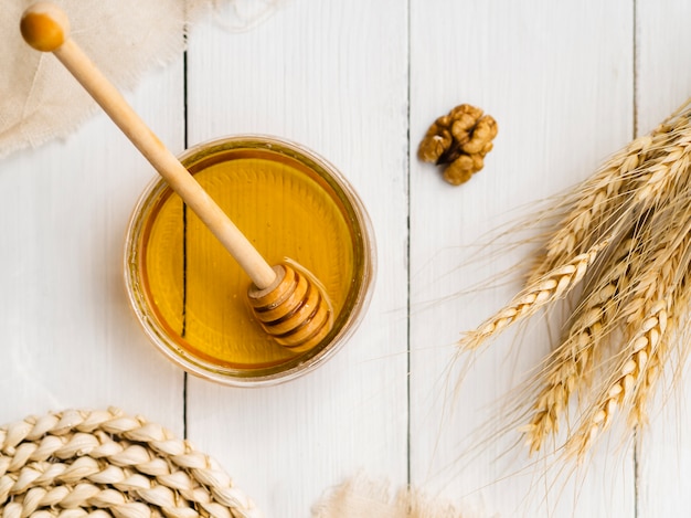 Top view honey next to wheat