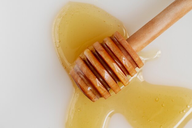 Top view of honey with honey dipper