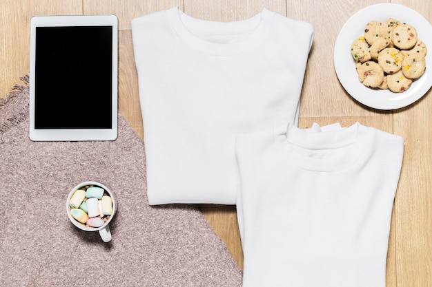 Free photo top view hoodie and plate with cookies