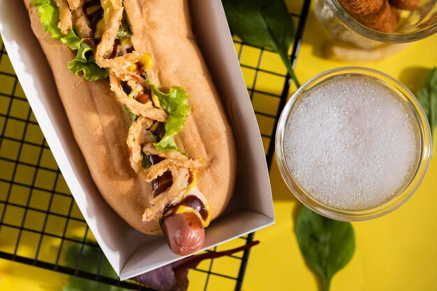 Top view of hot dog with salad and drink