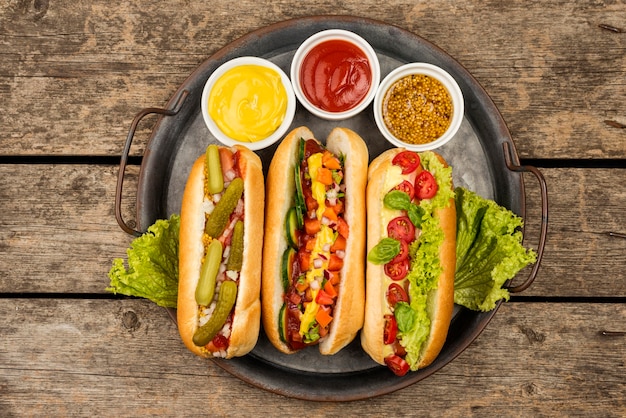 Top view hot dogs with sauce on plate