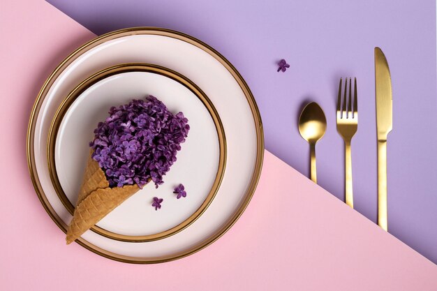 Top view ice cream cone with flowers on plate