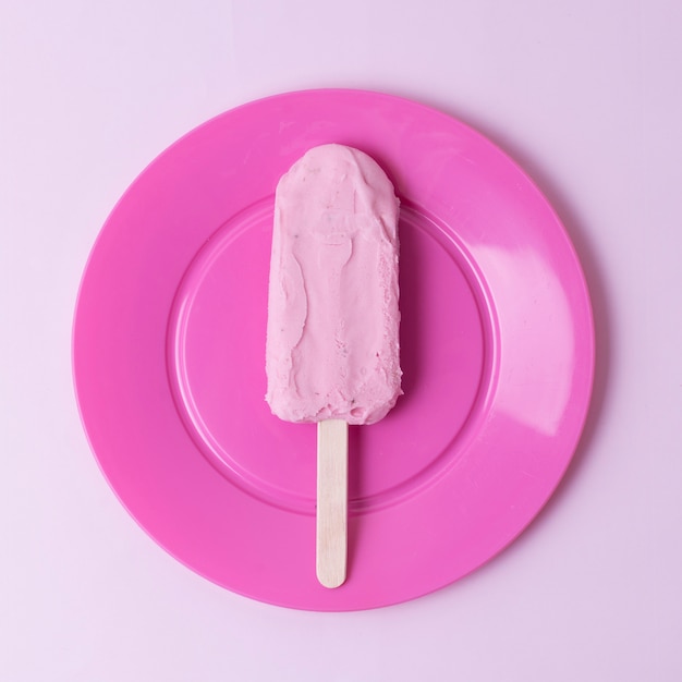 Top view ice cream on stick and pink plate