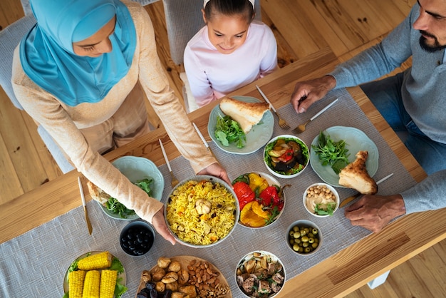 Free photo top view islamic family eating together