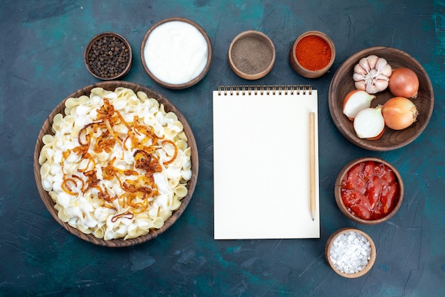 Free Photo top view italian pasta with different seasonings on dark-blue