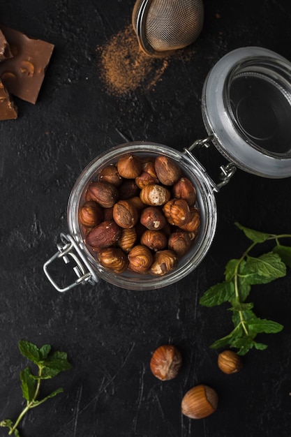 Free Photo top view jar filled with hazelnuts