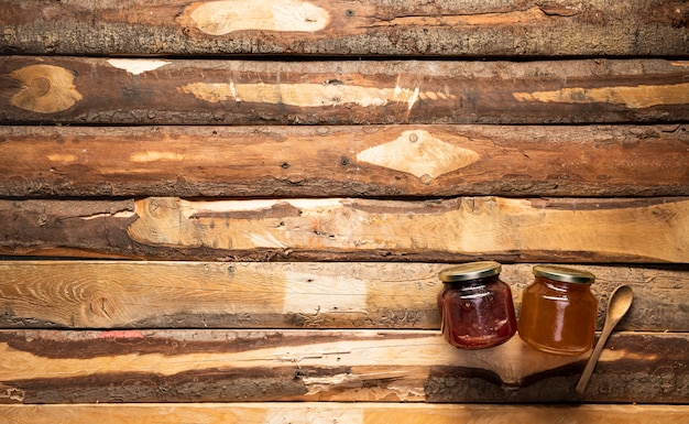 Top view jars of honey and jam with copy-space