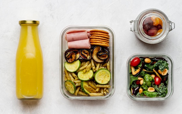 Free photo top view juice bottle and packed food