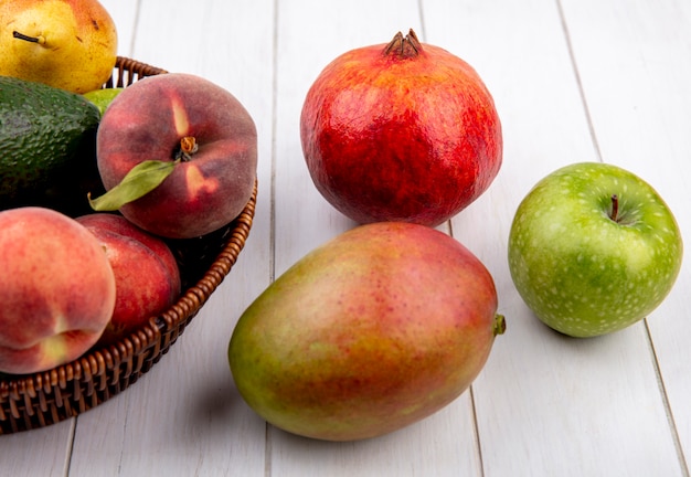 Free photo top view of juicy fruits such as peach pear on a bucket with apple mango isolated on a white surface