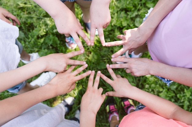 Free photo top view kids making a star with their hands