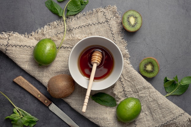 Top view of kiwi and bowl of honey