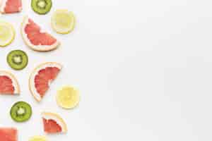 Free photo top view of kiwi and citrus fruits  with copy space