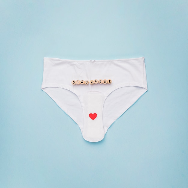 Free photo top view knickers with sanitary napkin and word