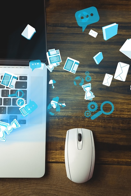 Top view of laptop and mouse with technology icons