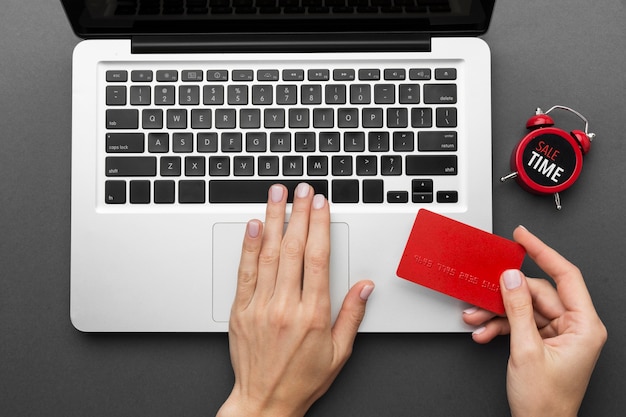 Free Photo top view laptop and red shopping card