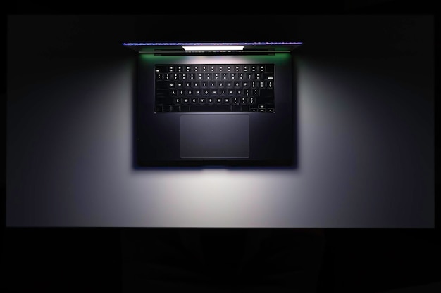 Free photo top view of a laptop on a table glowing screen in the dark