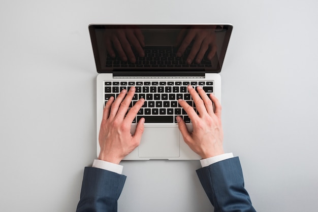 Top view of laptop with hands