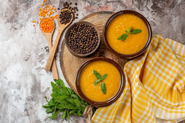 Top view lentils soup inside plates on light surface color seed plant soup food dish