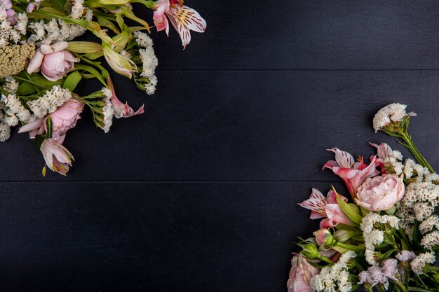 Top view of light pink flowers on a black surface