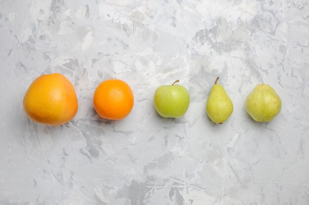 Top view lined fresh fruits pears and tangerines on white background