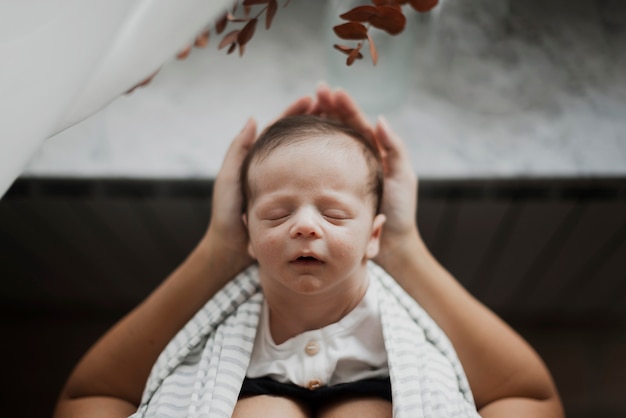 Top view little baby sleeping in mother hands