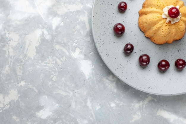 top view of little cake with cherries inside plate on grey-light, cake biscuit sugar sweet bake fruit