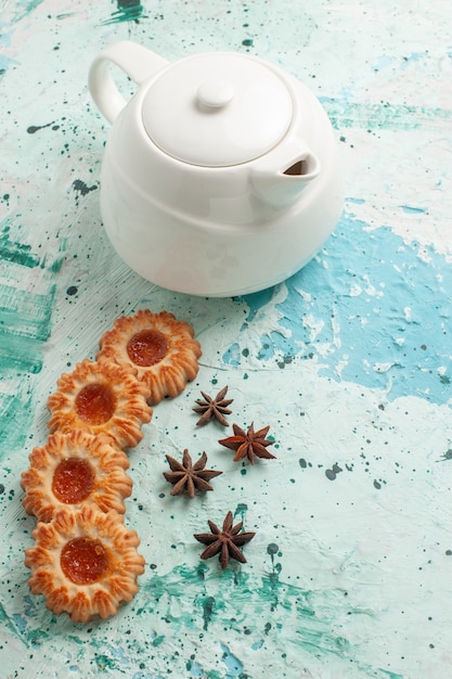 Free photo top view little cookies with kettle on light-blue surface