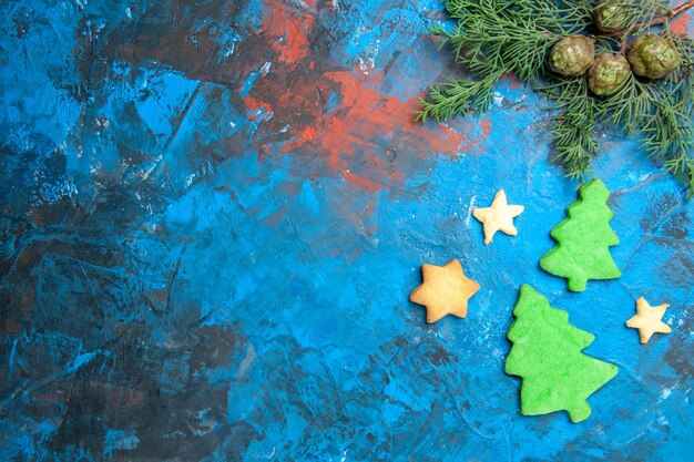 Top view of little tree figures on blue surface